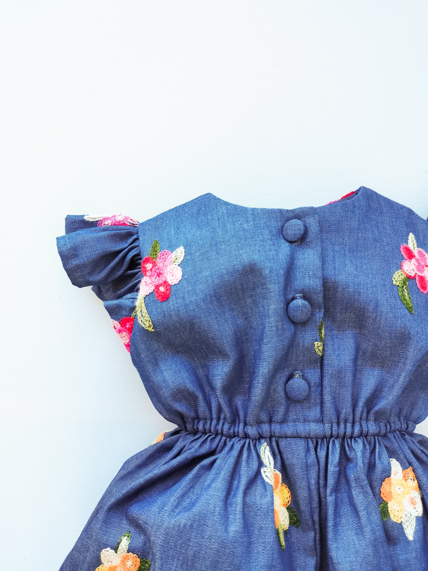 Chambray Little Robin's Romper, blue with embroidered flowers