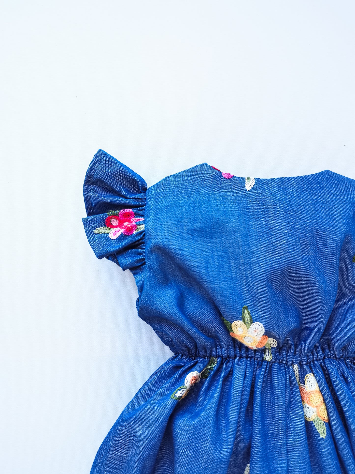 Chambray Little Robin's Romper, blue with embroidered flowers